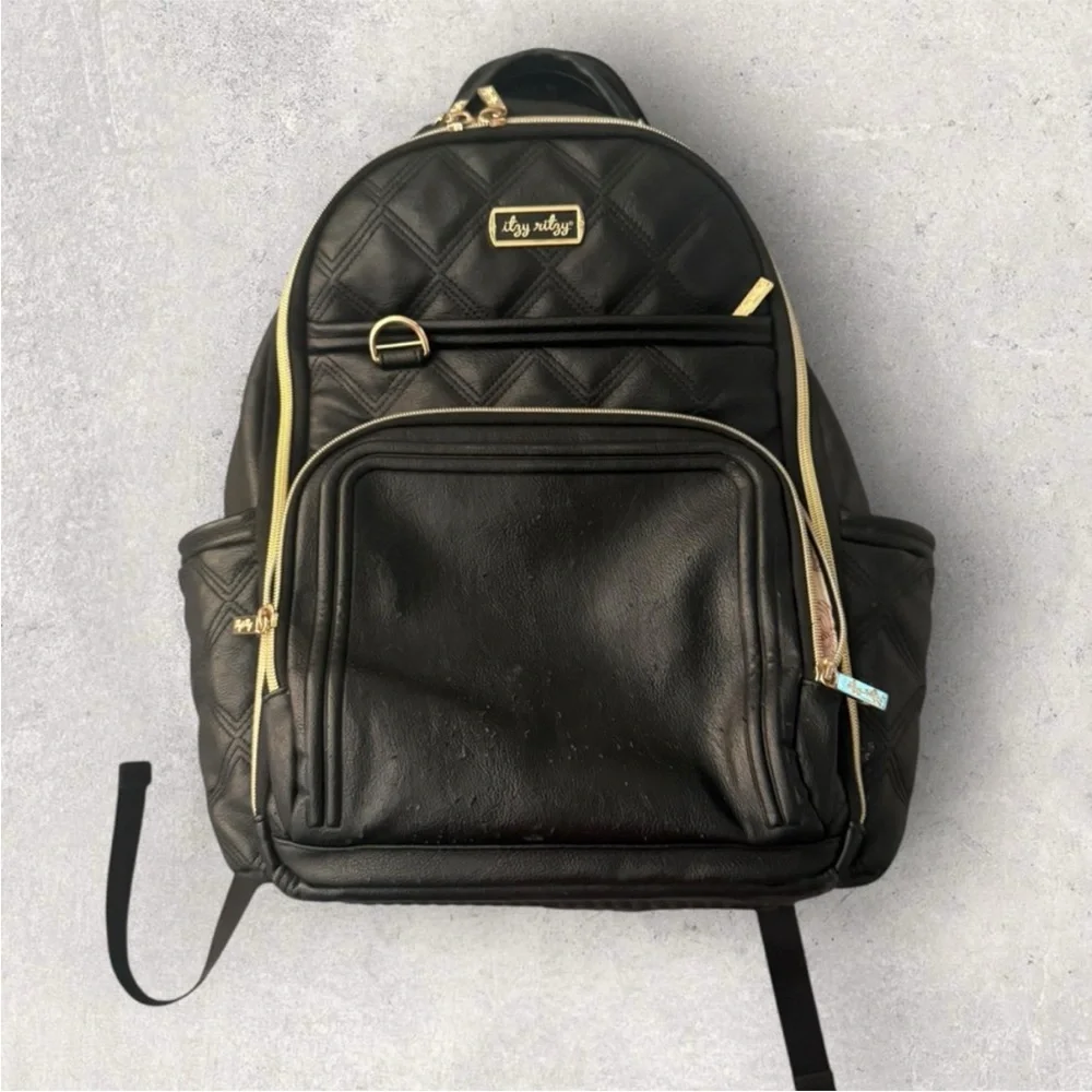 Itzy Ritzy Boss Plus black diaper bag backpack with gold hardware.